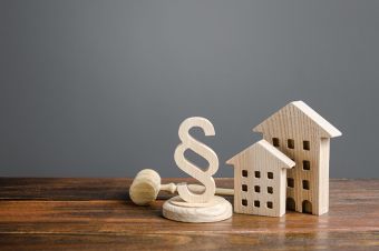 Foto: Häuser und Paragrafzeichen aus Holz